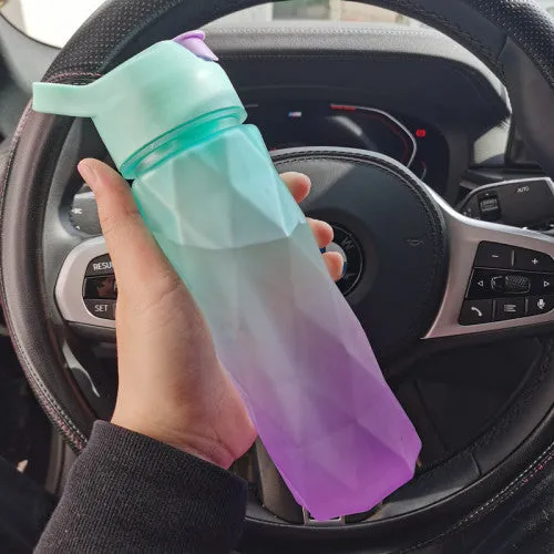 White 700ml plastic spray water bottle with handle strap and leakproof lid.
