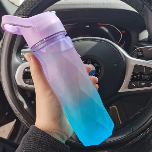 White 700ml plastic spray water bottle with handle strap and leakproof lid.
