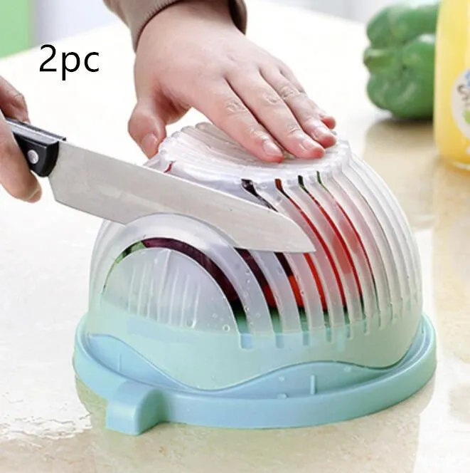 Blue salad cutter bowl with chopping lid and serving plate base on a kitchen counter