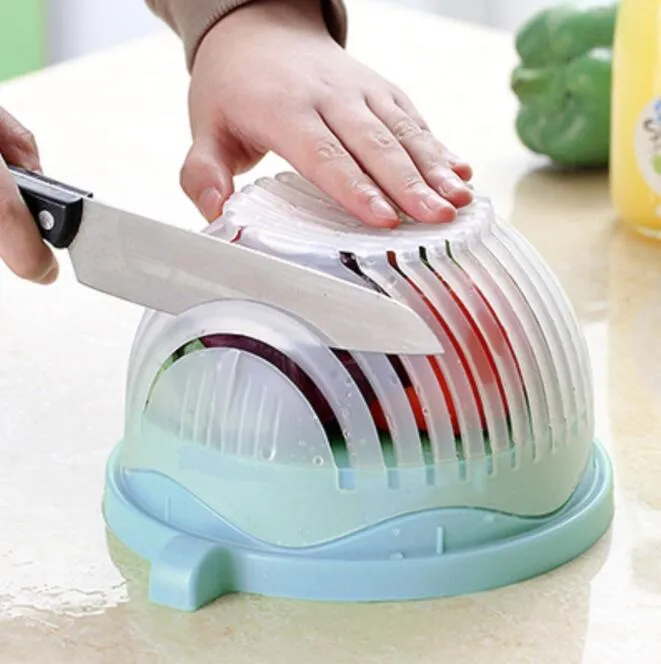 Blue salad cutter bowl with chopping lid and serving plate base on a kitchen counter