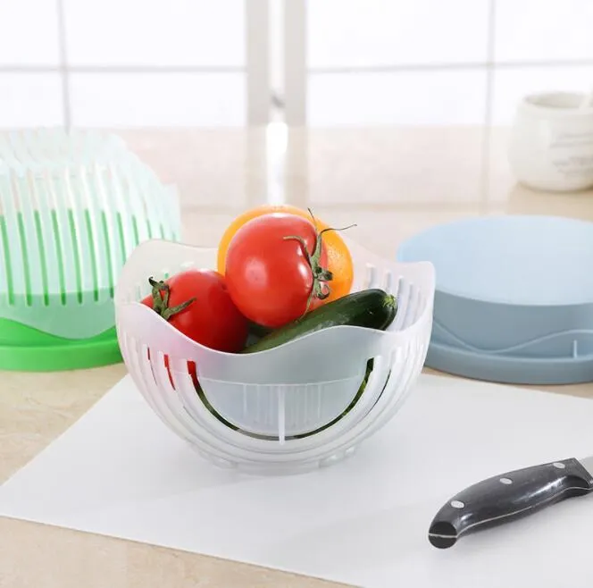 Blue salad cutter bowl with chopping lid and serving plate base on a kitchen counter