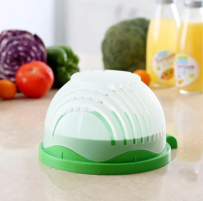 Blue salad cutter bowl with chopping lid and serving plate base on a kitchen counter