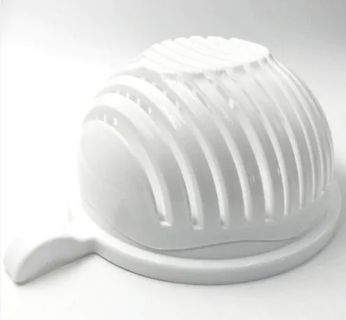 Blue salad cutter bowl with chopping lid and serving plate base on a kitchen counter