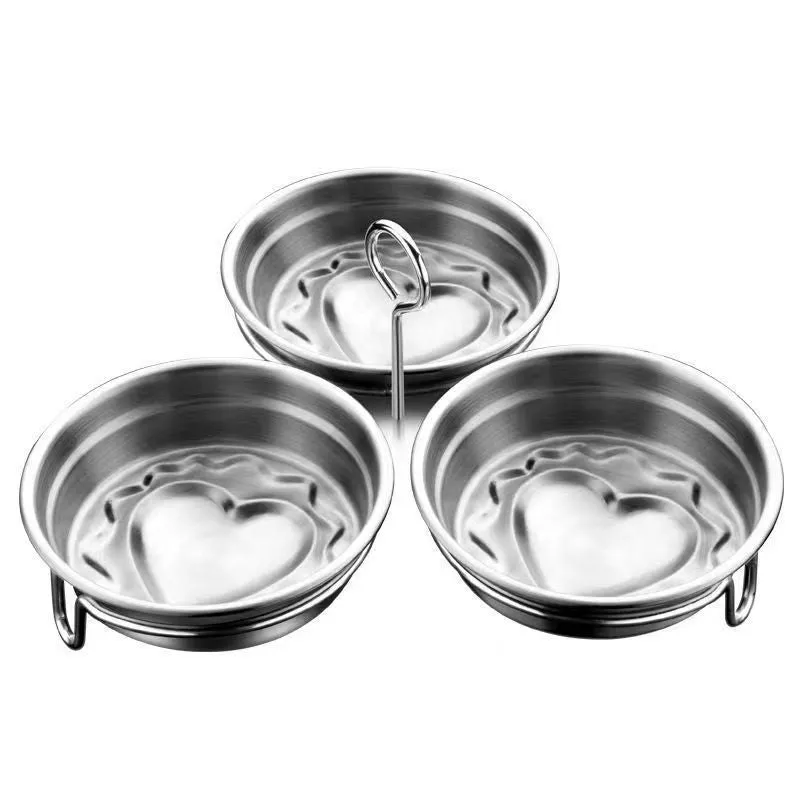 Mini stainless steel egg steamer in heart-shaped and round designs on a kitchen counter.