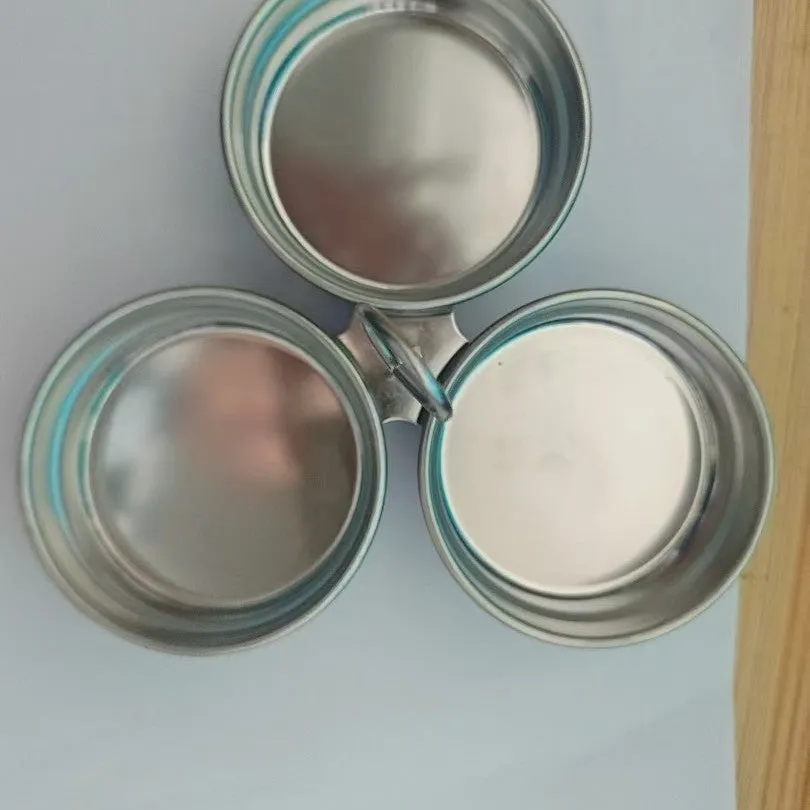Mini stainless steel egg steamer in heart-shaped and round designs on a kitchen counter.