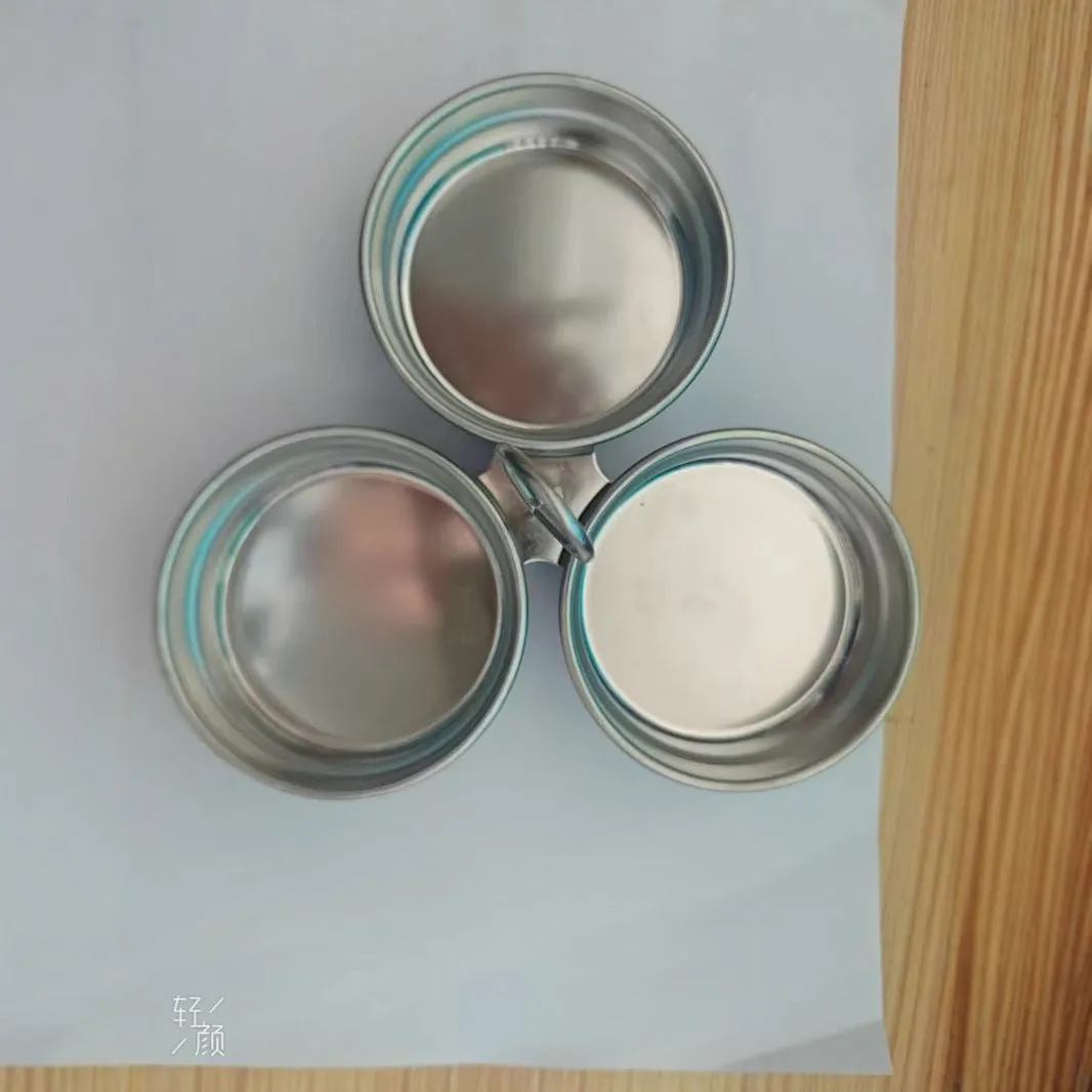 Mini stainless steel egg steamer in heart-shaped and round designs on a kitchen counter.