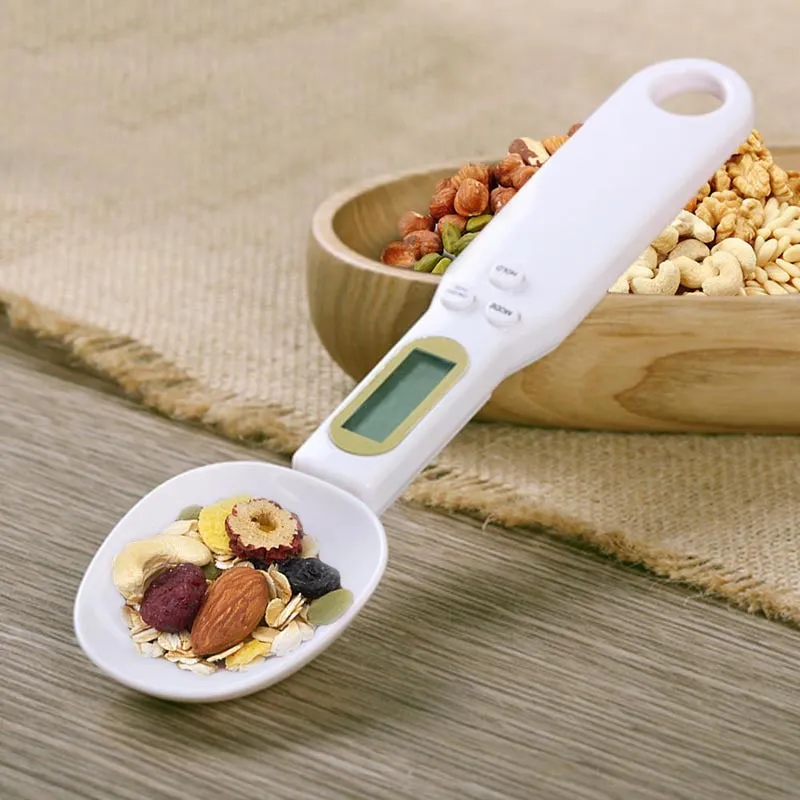 White digital spoon scale with LCD display showing weight measurement for kitchen use