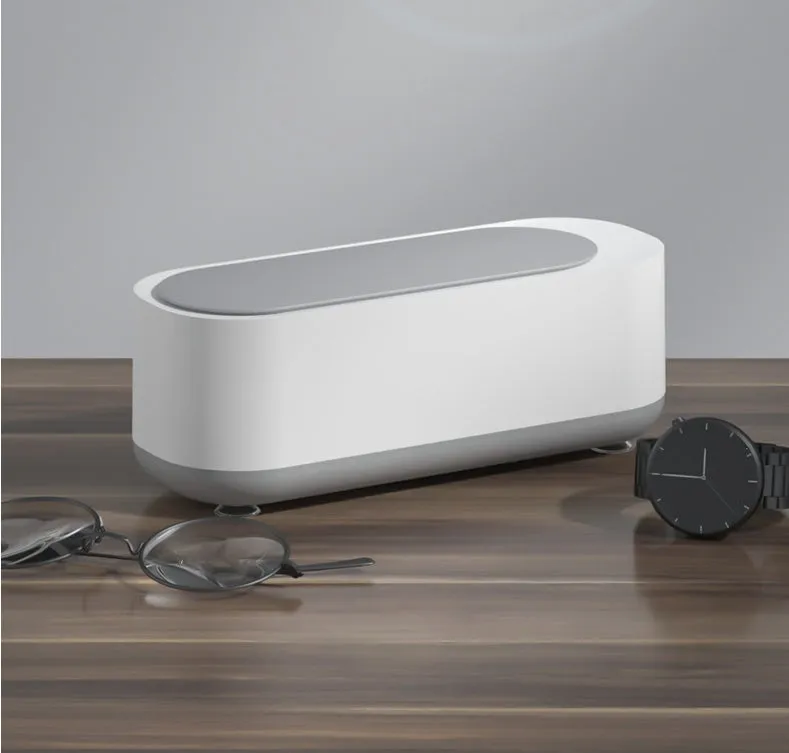 Off-white ultrasonic cleaning machine with stainless steel tank for jewellery and glasses.