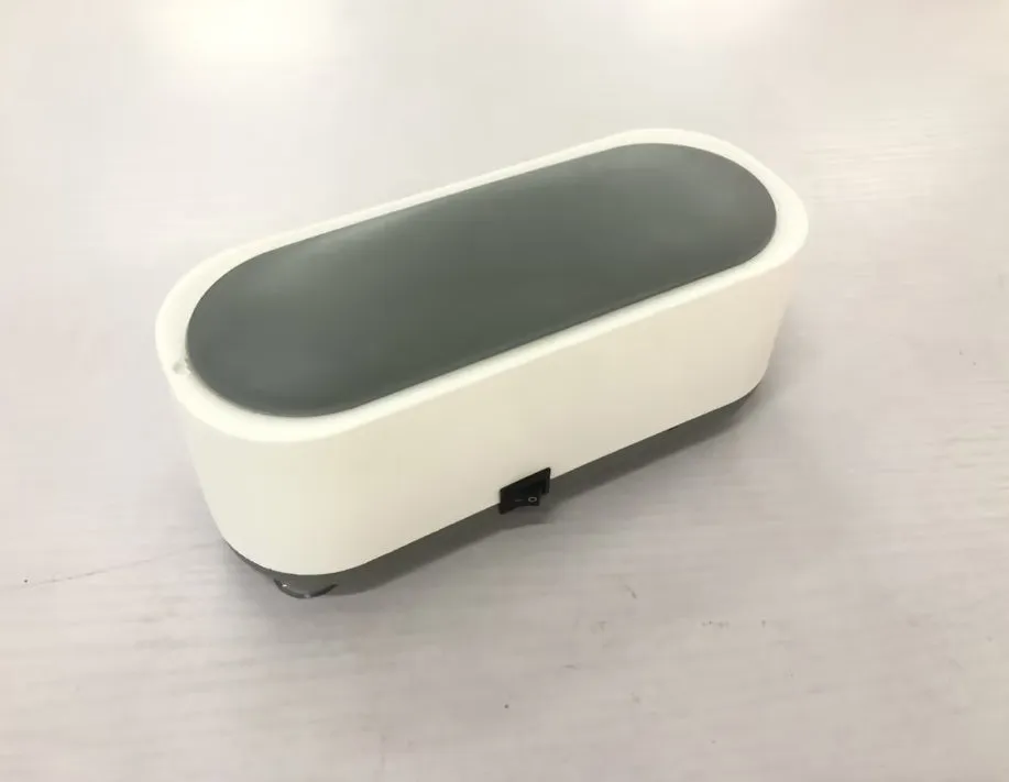 Off-white ultrasonic cleaning machine with stainless steel tank for jewellery and glasses.