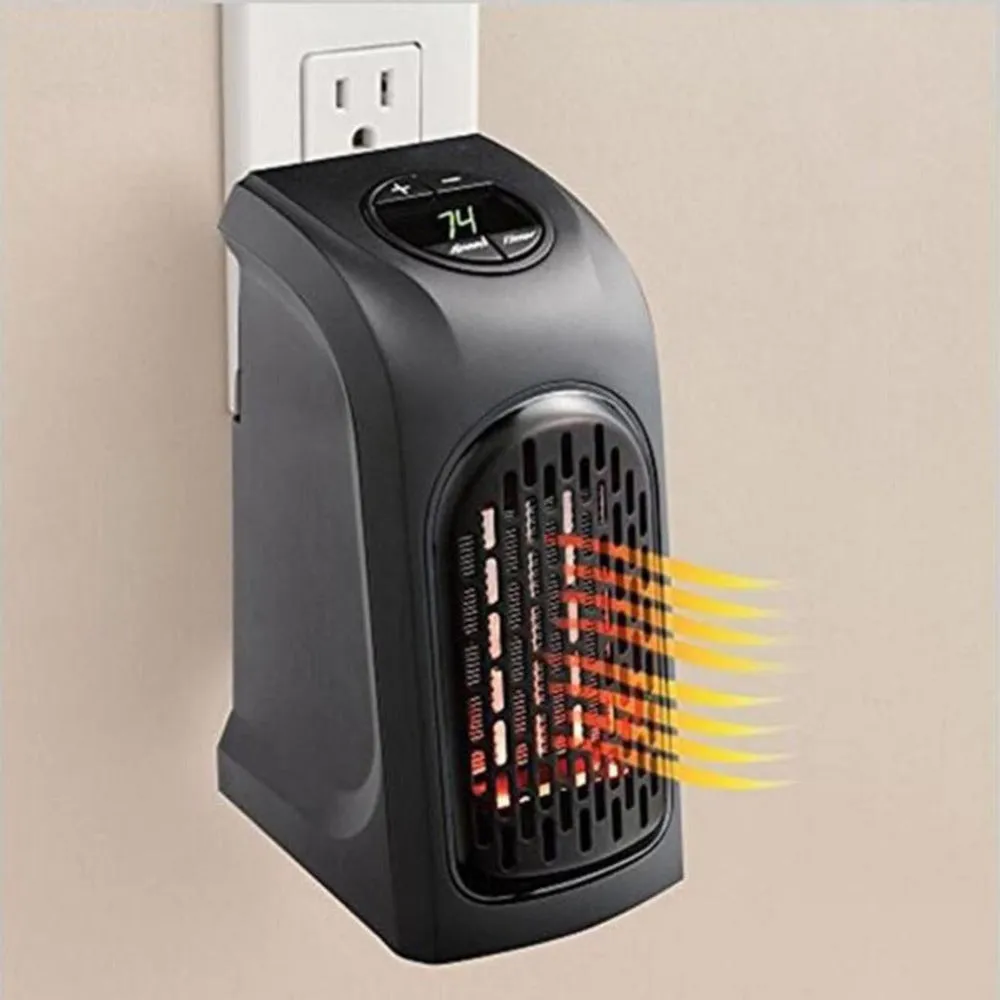 Small black ceramic fan heater with mechanical controls on a desk.