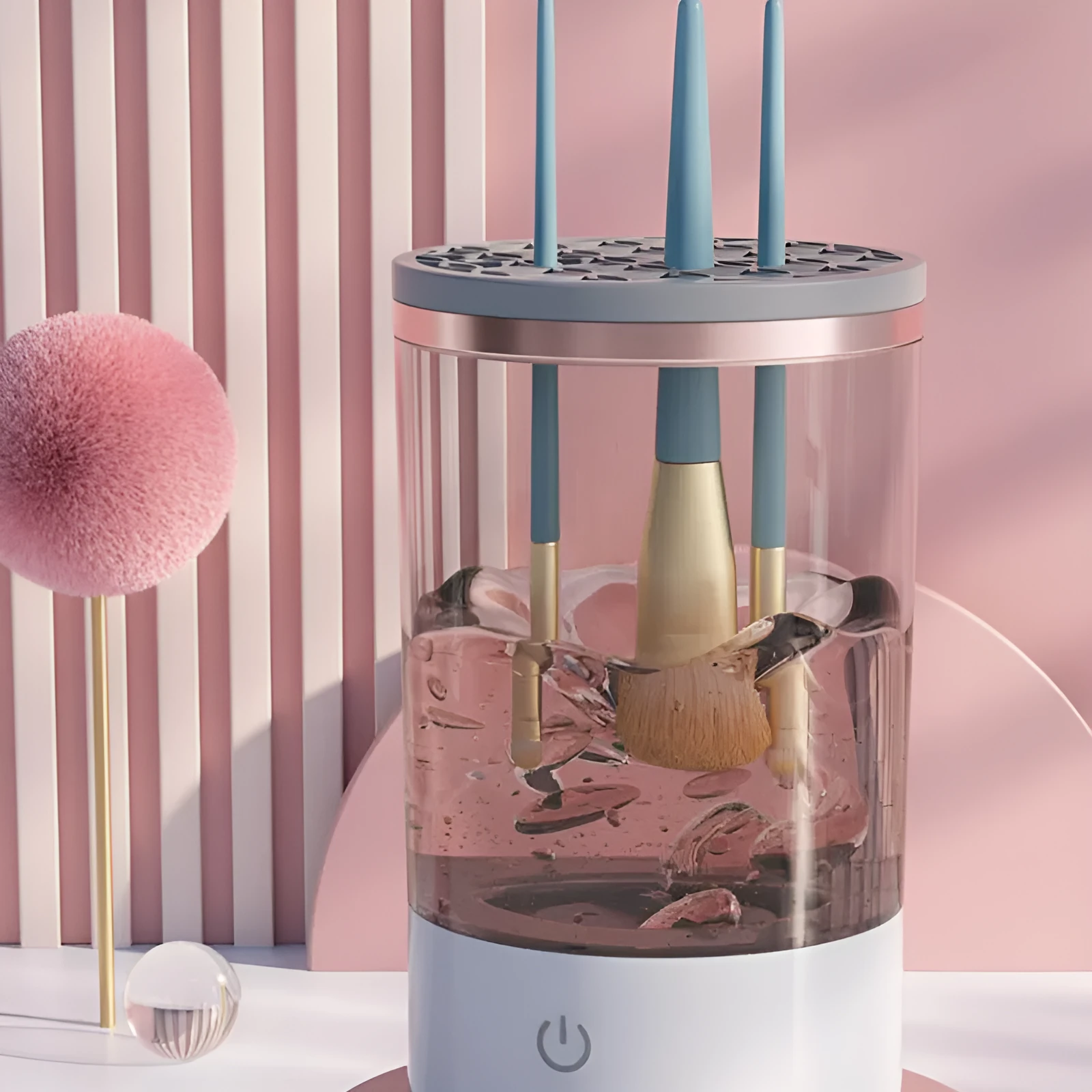 Grey and white portable electric makeup brush cleaner with USB cable.