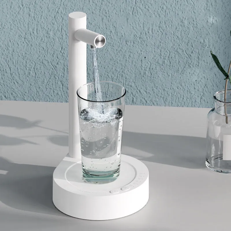 White electric water dispenser pump with USB cable next to water gallon bottle