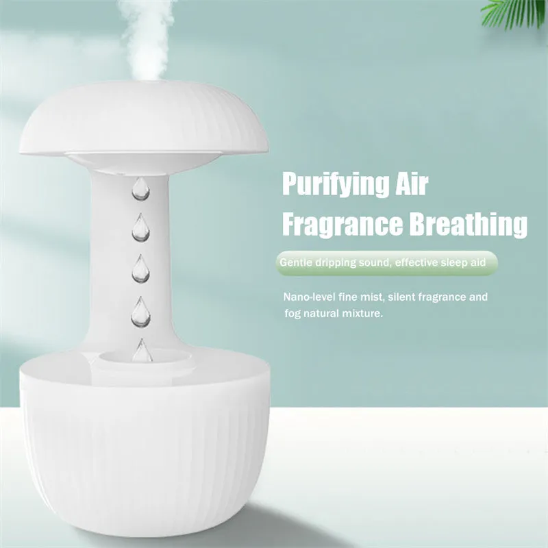 White anti-gravity humidifier showing water droplets levitating upwards from its mist outlet.