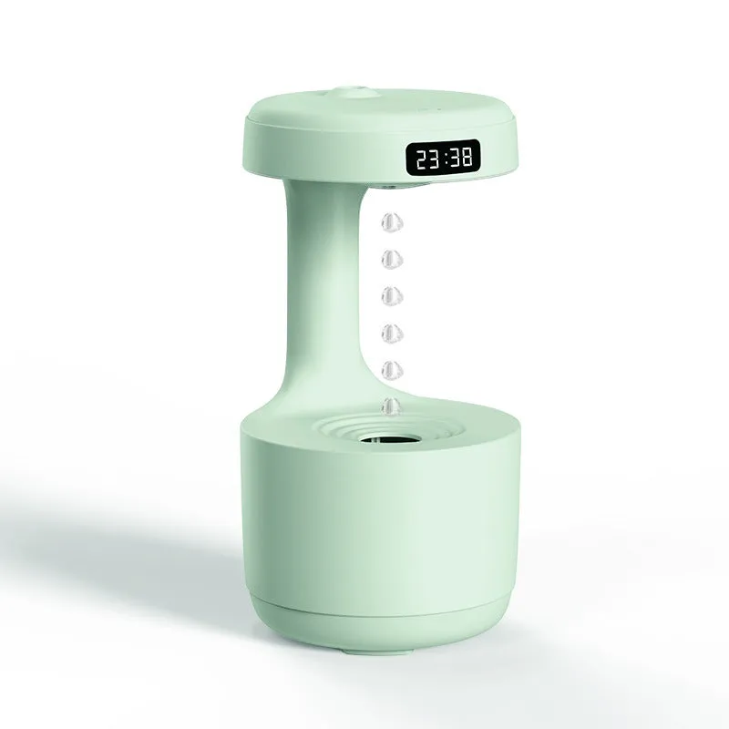White anti-gravity humidifier showing water droplets levitating upwards from its mist outlet.