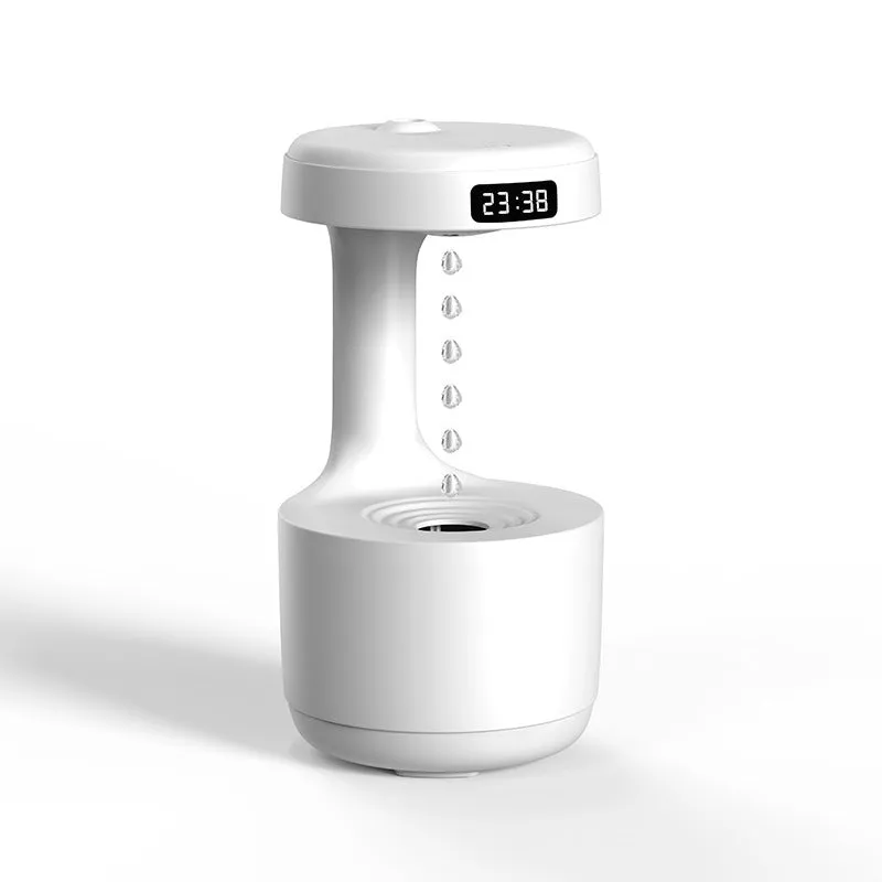 White anti-gravity humidifier showing water droplets levitating upwards from its mist outlet.