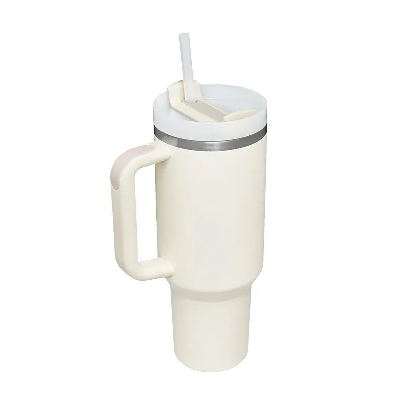 40 oz stainless steel insulated tumbler with a black handle, straw, and grey lid on a wooden table