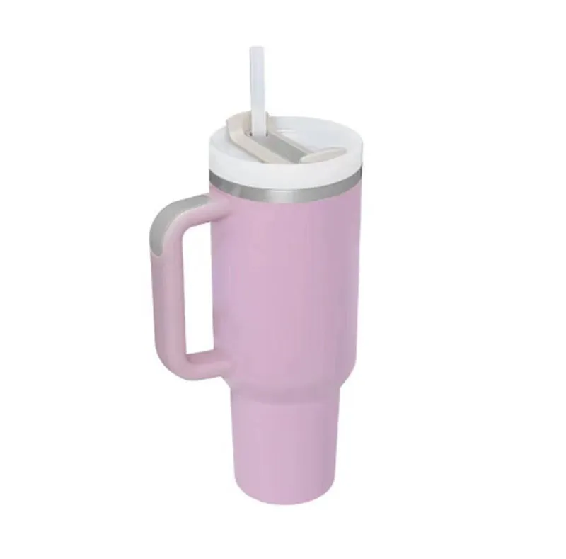 40 oz stainless steel insulated tumbler with a black handle, straw, and grey lid on a wooden table