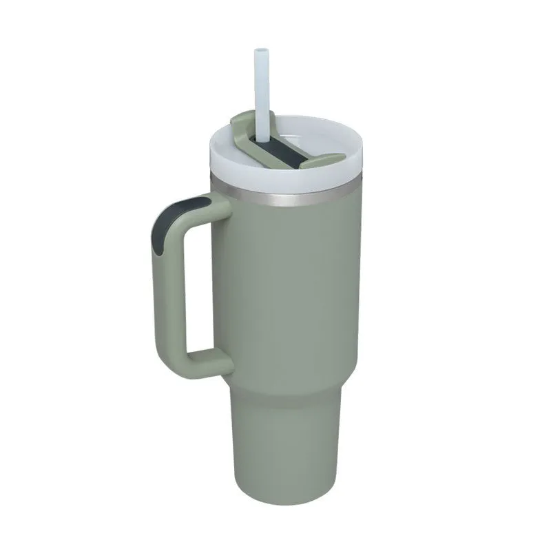 40 oz stainless steel insulated tumbler with a black handle, straw, and grey lid on a wooden table