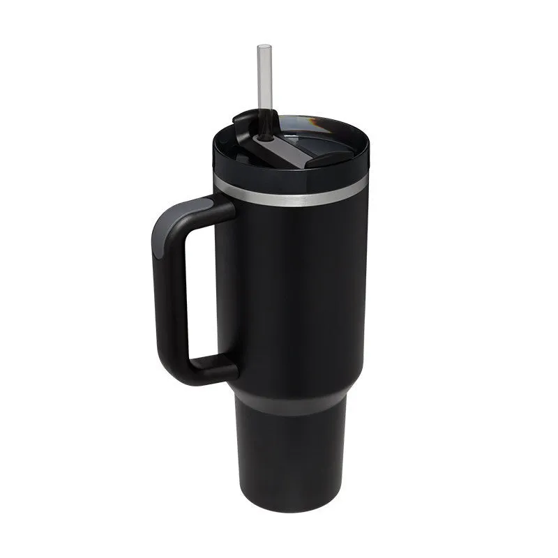 40 oz stainless steel insulated tumbler with a black handle, straw, and grey lid on a wooden table