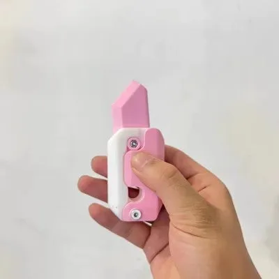 3D printed carrot gravity fidget knife in orange purple green colour, showing blade partly extended from sheath