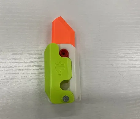 3D printed carrot gravity fidget knife in orange purple green colour, showing blade partly extended from sheath