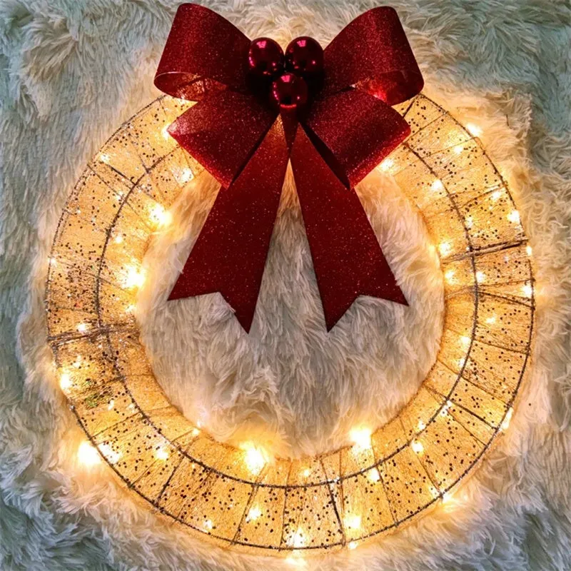 50cm gold and green Christmas garland with LED lights and bowknot on a door
