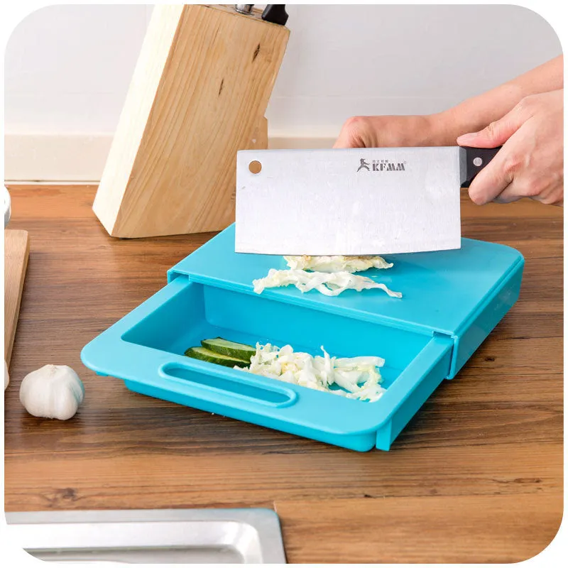 Blue kitchen chopping board with built-in sink drain basket and TPE handle on a counter.