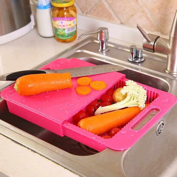 Blue kitchen chopping board with built-in sink drain basket and TPE handle on a counter.