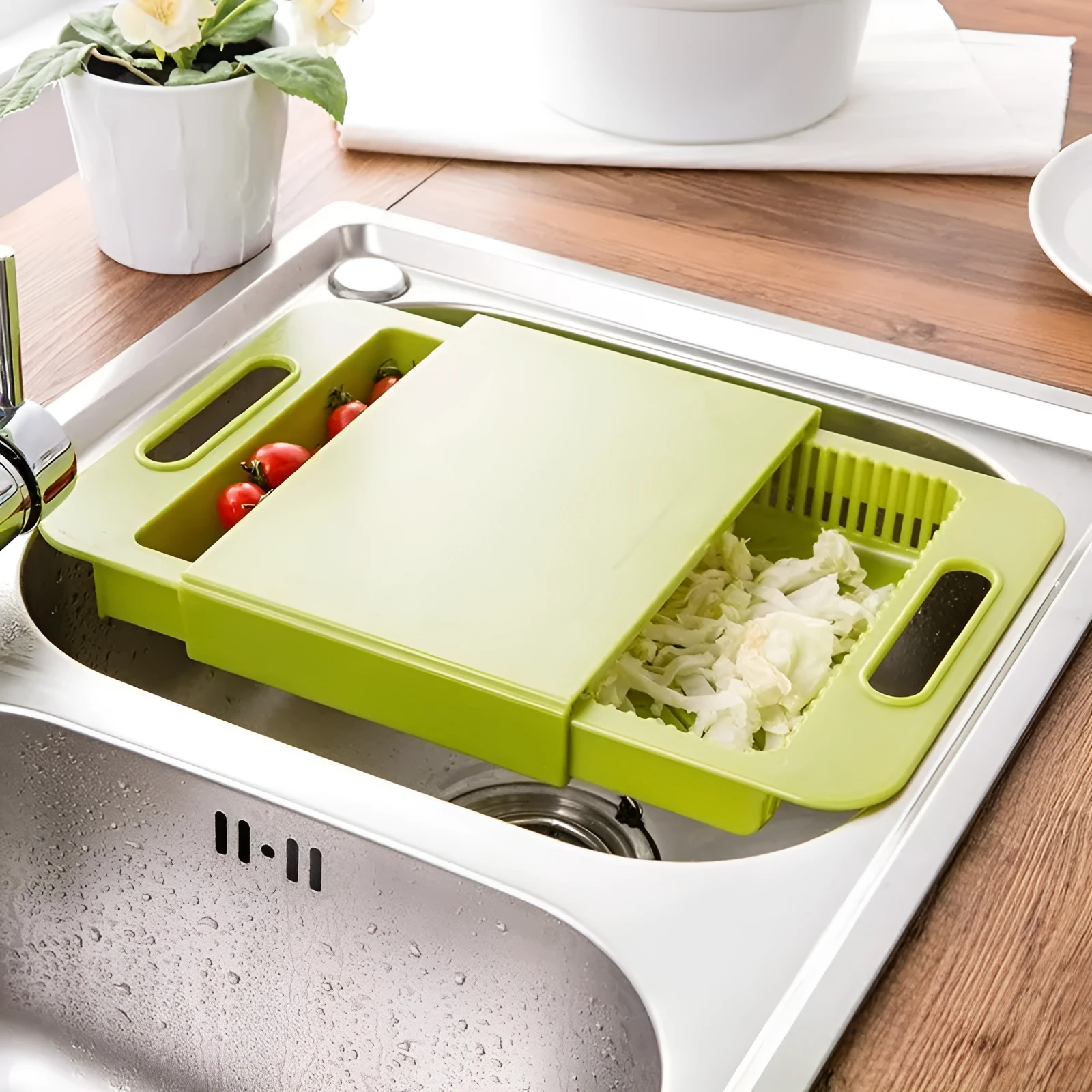 Blue kitchen chopping board with built-in sink drain basket and TPE handle on a counter.