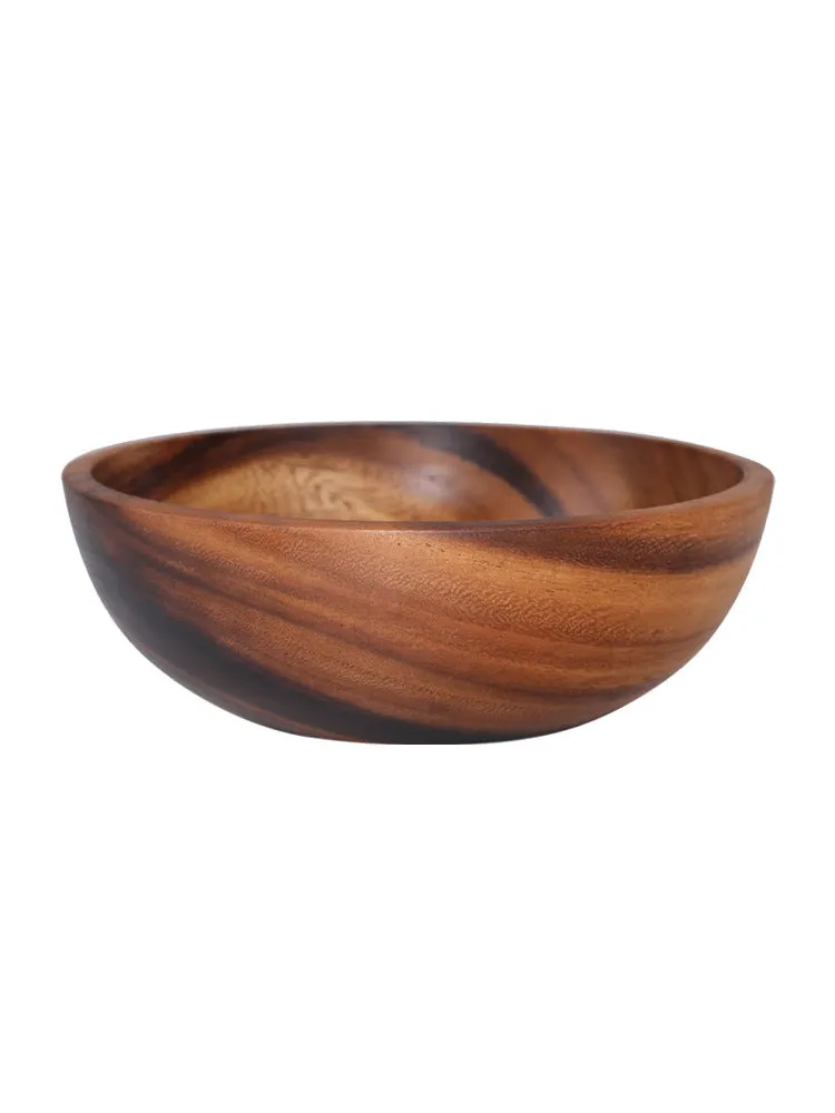 Handmade brown wooden bowl set showing multiple sizes from small to large on wooden table