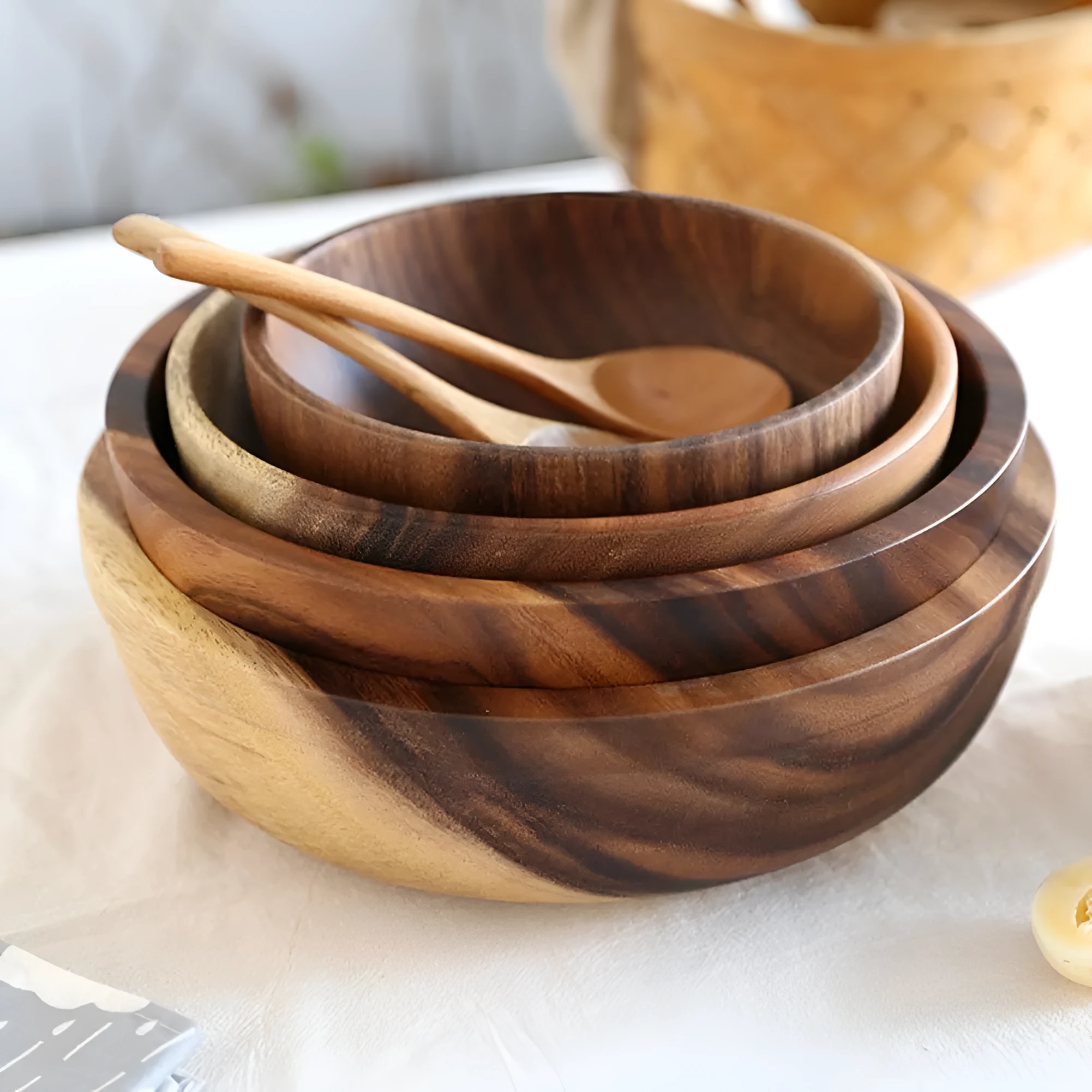 Handmade brown wooden bowl set showing multiple sizes from small to large on wooden table
