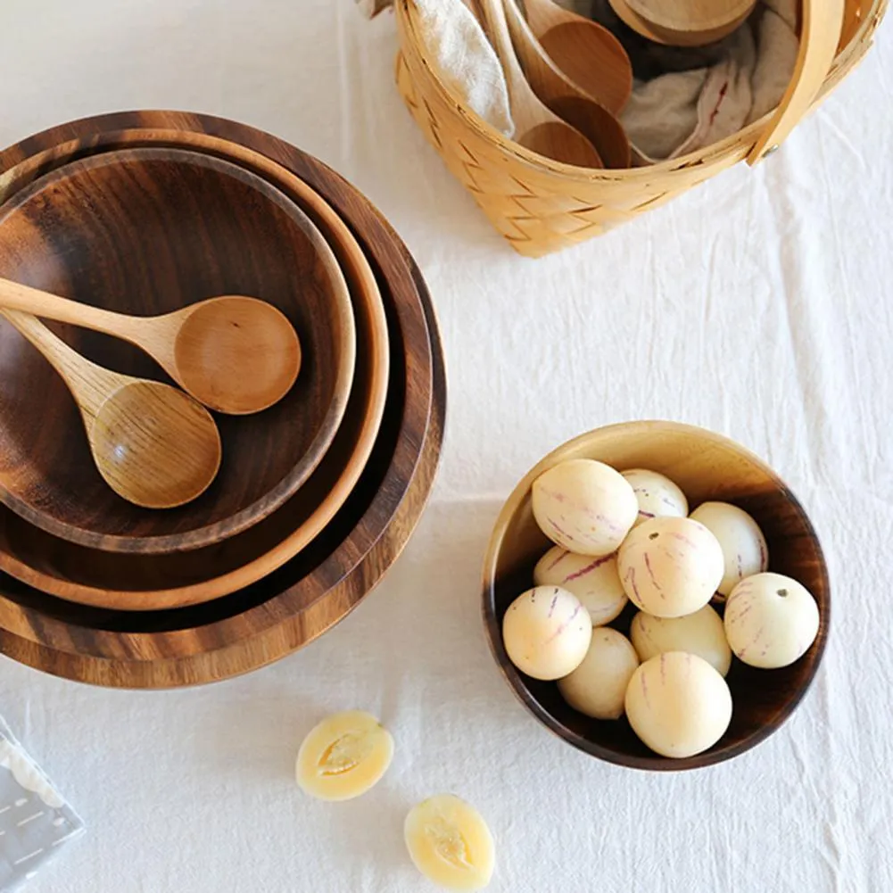 Handmade brown wooden bowl set showing multiple sizes from small to large on wooden table