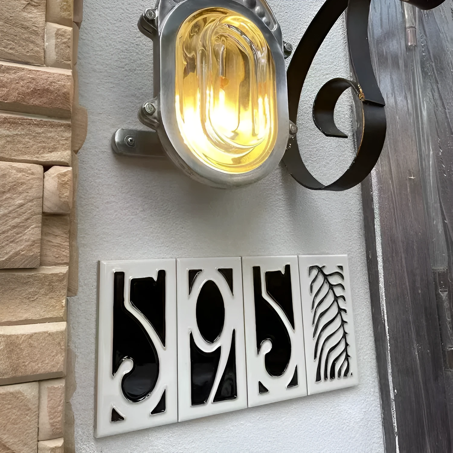 Handmade retro-style ceramic doorplate with an enamel art number on a white background.