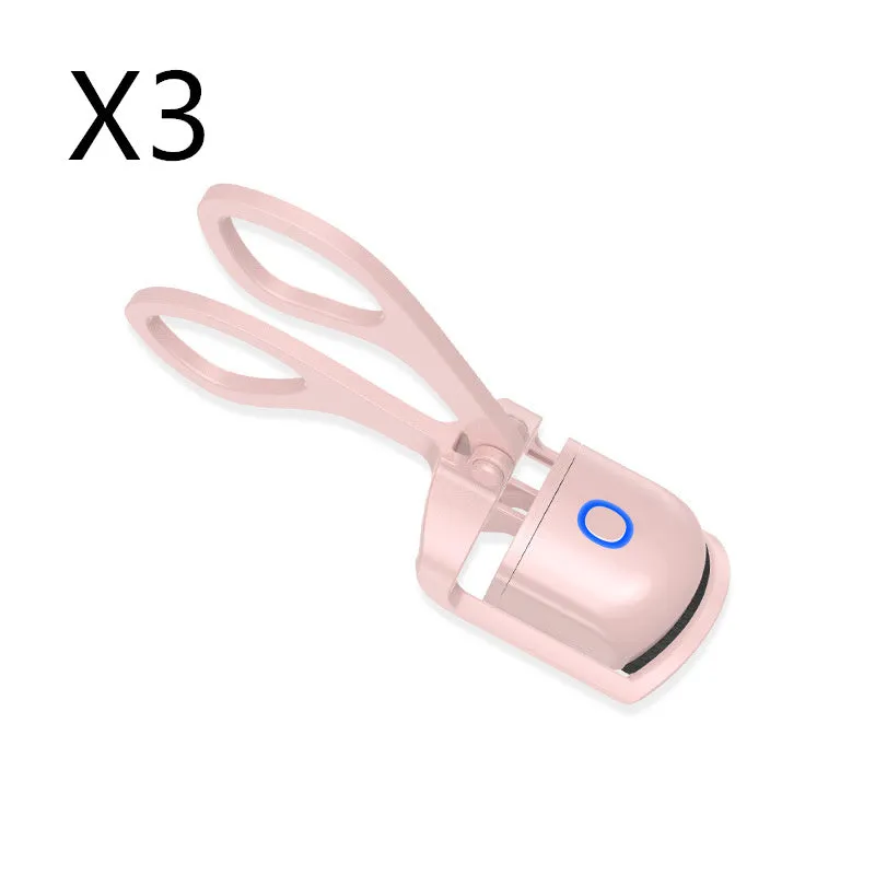 White and pink USB rechargeable heated eyelash curler with curved silicone pad.