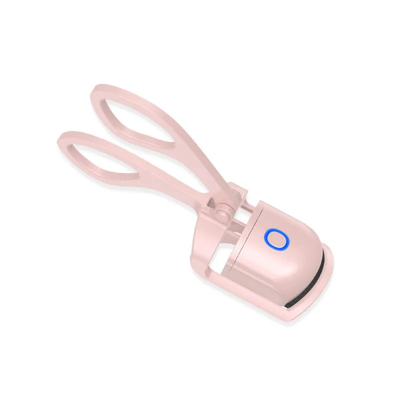 White and pink USB rechargeable heated eyelash curler with curved silicone pad.