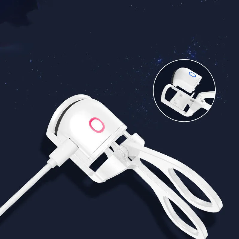 White and pink USB rechargeable heated eyelash curler with curved silicone pad.