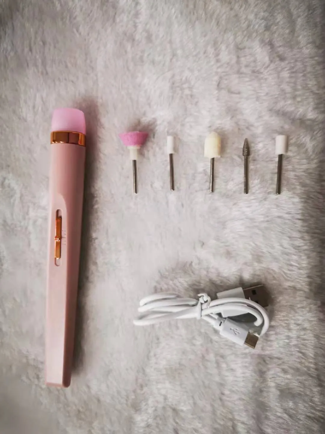 5in1 cordless rechargeable nail drill set with LED light, five abrasive heads, and USB cable on white background