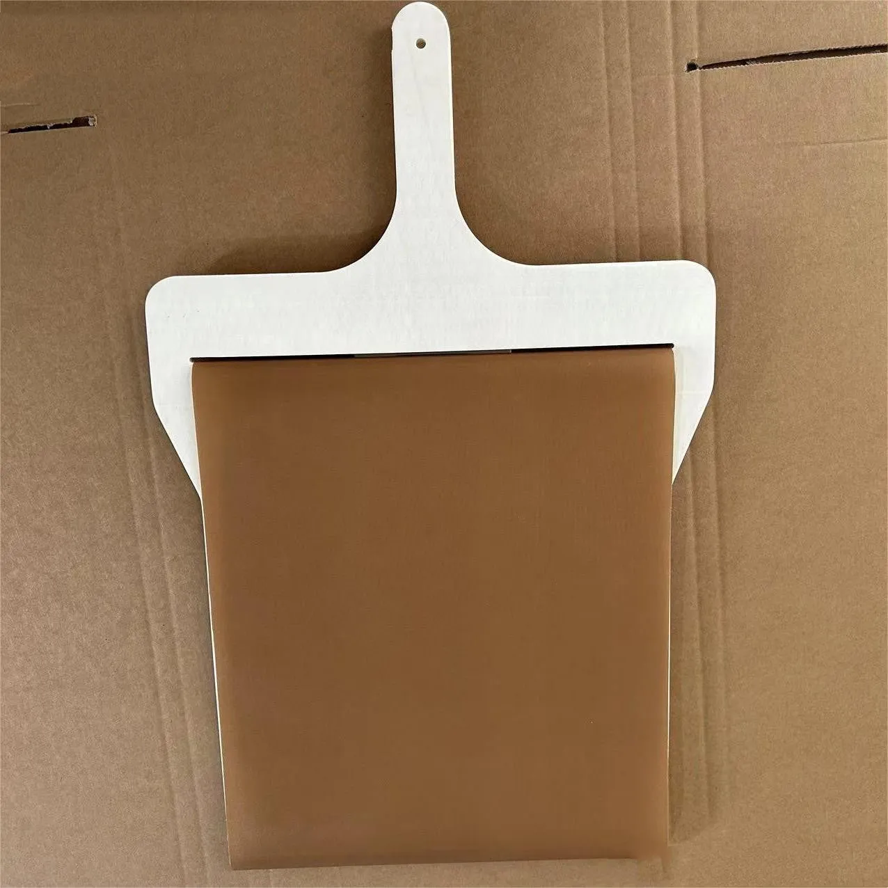 Natural wood sliding pizza peel in log colour with wooden handle, available in three sizes for transferring baked goods