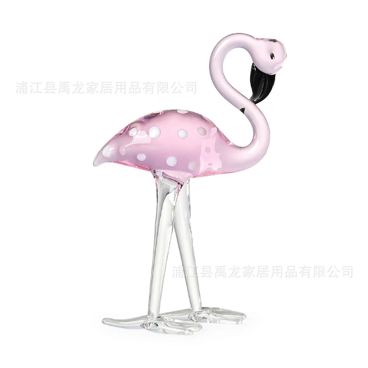 Pink flamingo decorative ornament made of white crystal on a table.