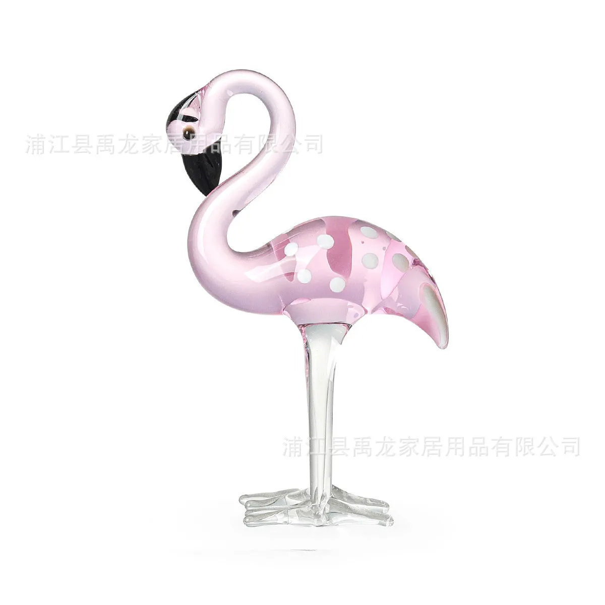 Pink flamingo decorative ornament made of white crystal on a table.