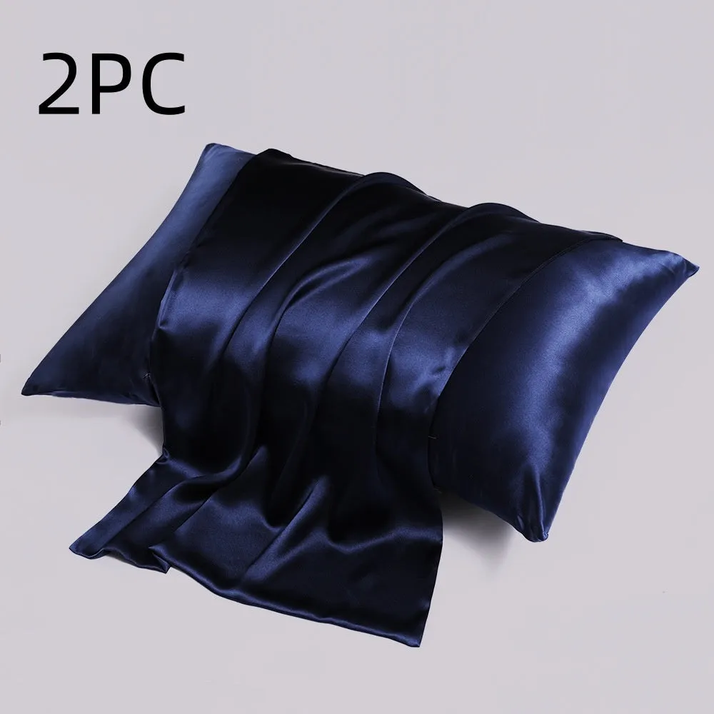 Close-up of a navy blue silk pillowcase showing a discreet zipper closure along the seam.