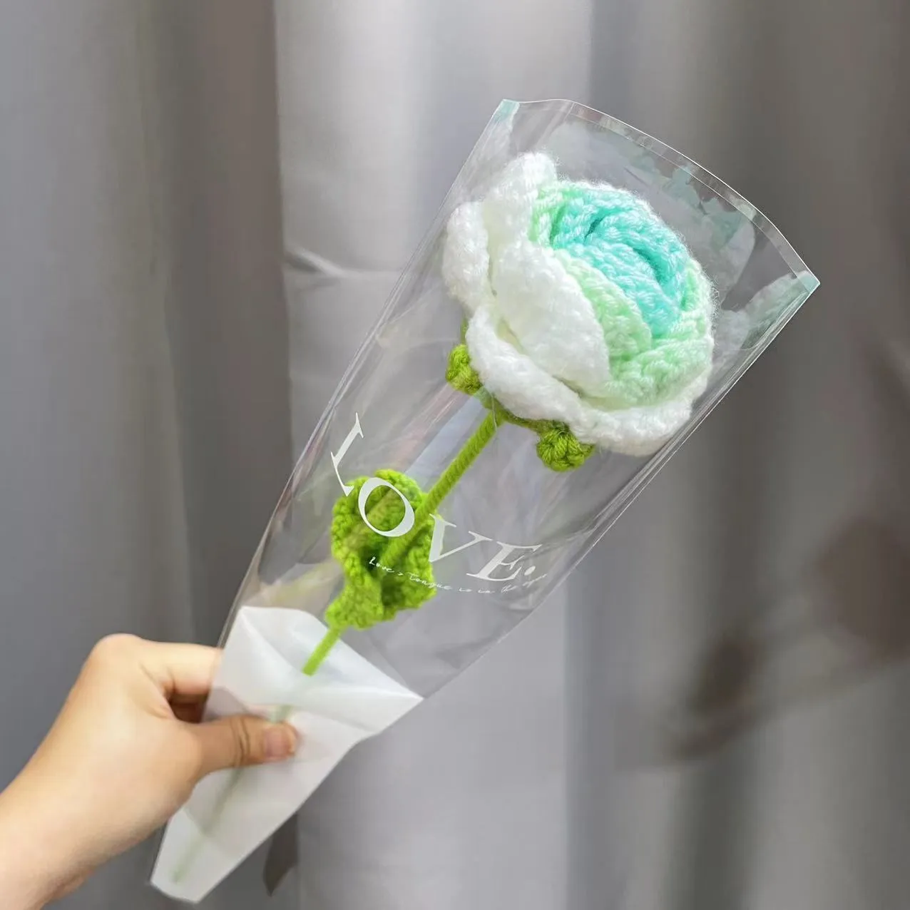Artificial silk rose bouquet with blue gradient wool-weave petals on a single stem.