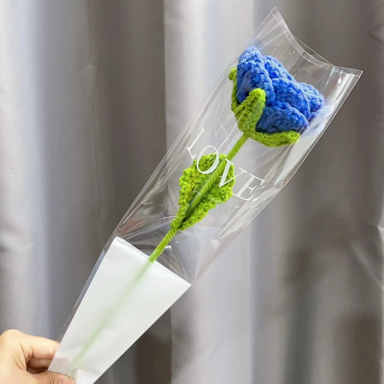 Artificial silk rose bouquet with blue gradient wool-weave petals on a single stem.