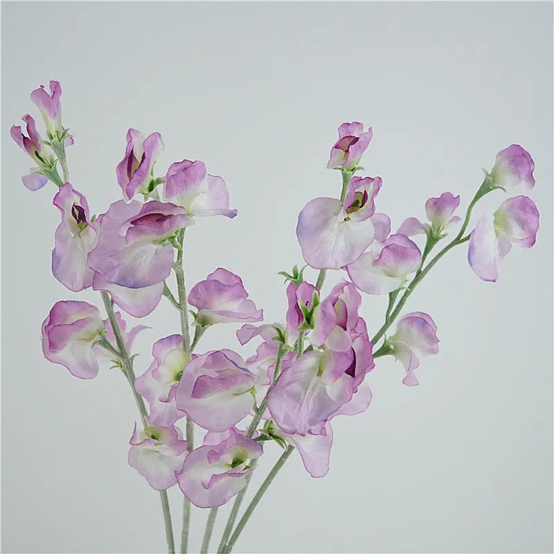 Silk artificial pea flower single stem in pink with green wire stem on white background