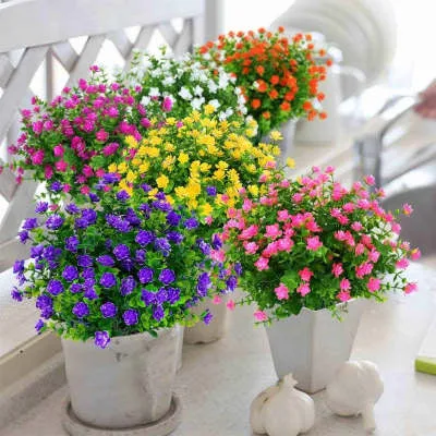 Artificial eucalyptus camellia plastic bouquet in mixed colours on white background