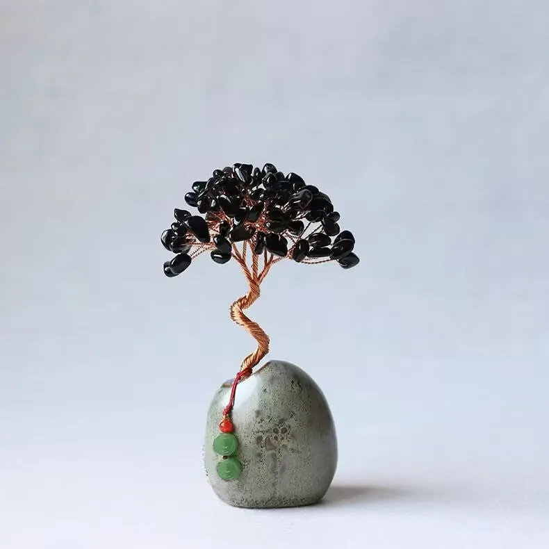 Natural citrine crystal Pachira Macrocarpa lucky ornament on a plain background.