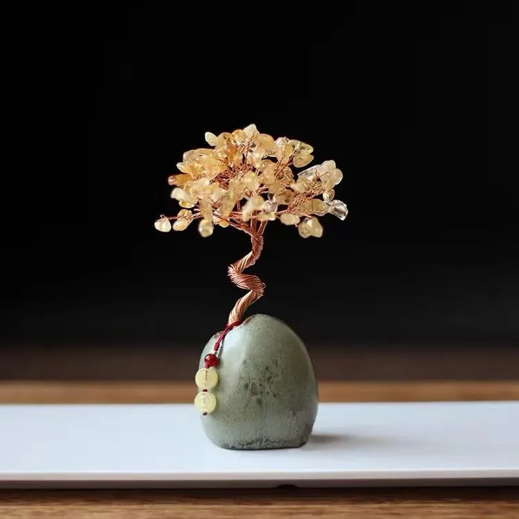 Natural citrine crystal Pachira Macrocarpa lucky ornament on a plain background.