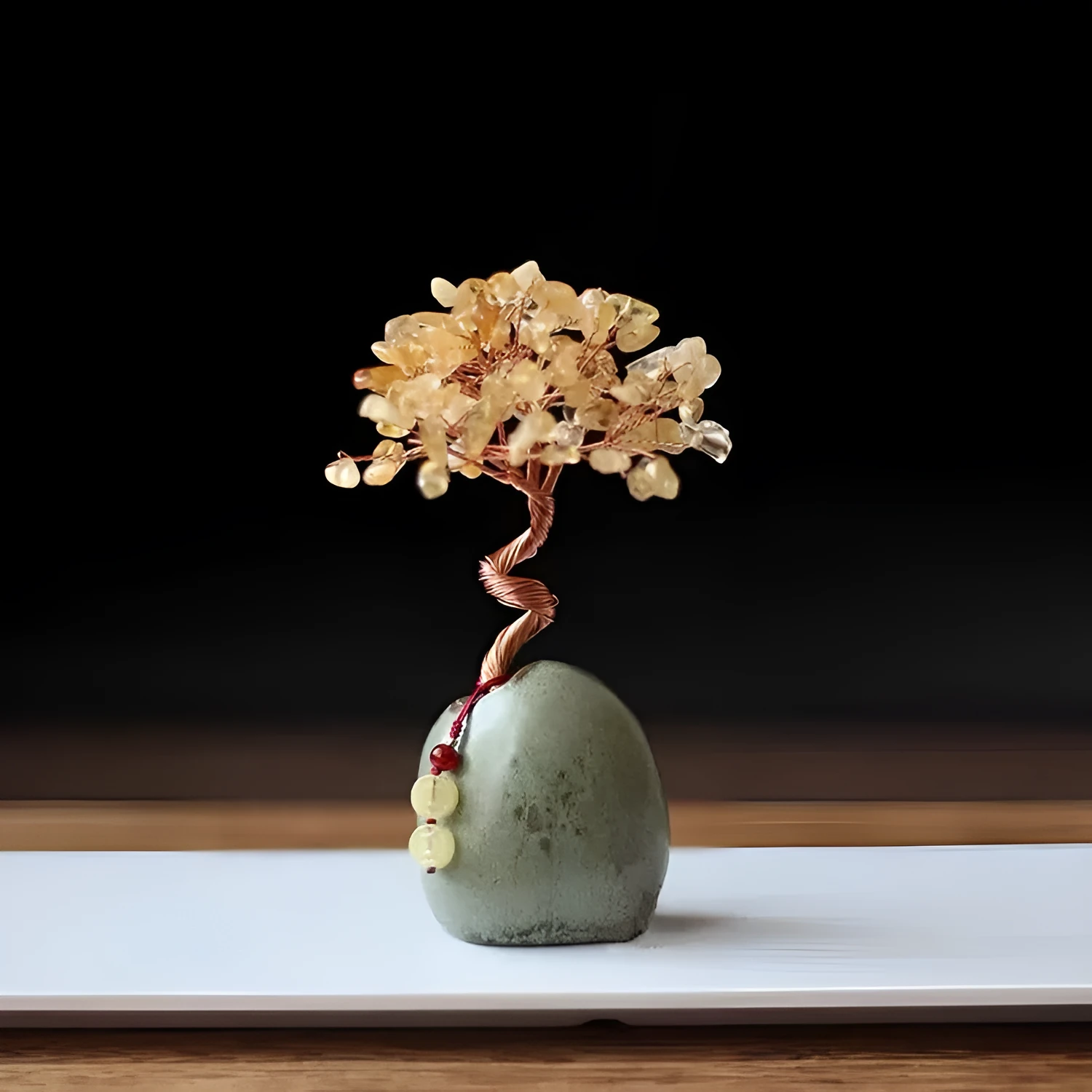 Natural citrine crystal Pachira Macrocarpa lucky ornament on a plain background.