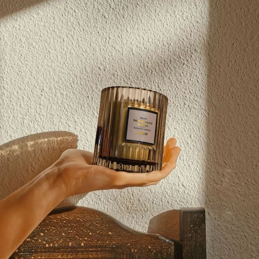 Cylindrical soy wax aromatherapy candle in amber colour with smooth surface