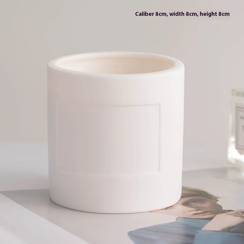 Ceramic candlestick with minimalist relief pattern on a dining table